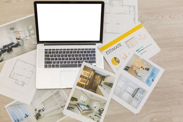 computer laptop on architectural drawing paper for construction white