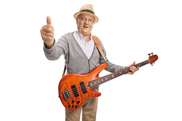 Mature man with a bass guitar showing thumb up