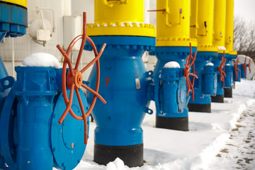 The valves for opening and closing the gas supplying at the gas compressor station in winter. Blue...