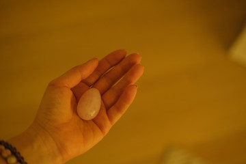 Woman holds yoni egg in hand