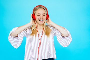Dancing girl listens to music in earphones