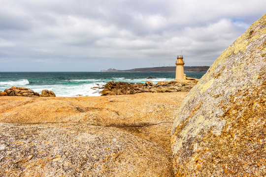 Muxia or Mugia rocky coastal view with the lighthouse, Faro de Muxia on the Way of St. James, Camino de Santiago, Province of A Coruna, Galicia, Spain