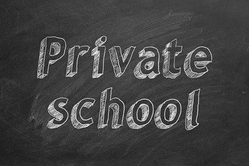 Hand drawing "Private school" on black chalkboard. 