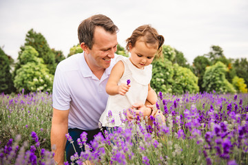 Happy family father and daughter having fun in lavender field