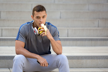 Young latin man eating banana fruit runner fitness copyspace copy space sports training