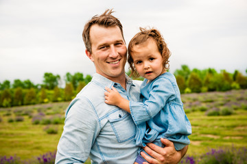 Fototapeta premium Happy family father and daughter having fun in lavender field