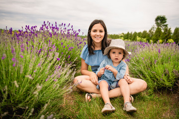 Fototapeta premium Happy family mother and daughter having fun in lavender field