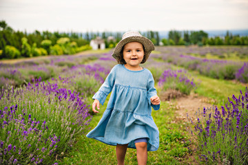 Child in a lavender field. Happy child in nature.