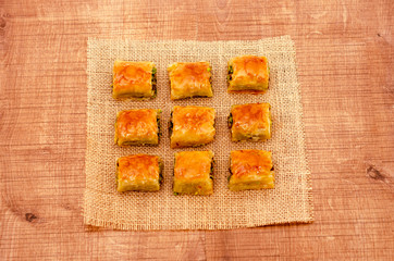 Turkish dessert baklava on wooden plate pattern