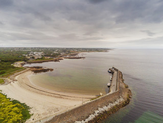 Pier and beach in Spiddal town, county Galway, Ireland. Aerial view, Cloudy sky. Landscape.