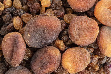 close-up of yellow seedless raisins and day dried apricots, on a plate