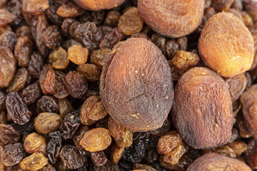 close-up of yellow seedless raisins and day dried apricots, on a plate