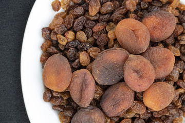 close-up of yellow seedless raisins and day dried apricots, on a plate