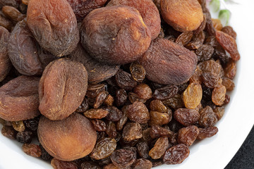 close-up of yellow seedless raisins and day dried apricots, on a plate
