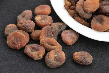 Fototapeta na wymiar dried apricots, day dry on a plate apricots, dired apricots specific natural turkey,