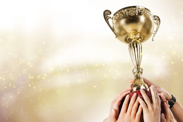 The winning team holds the gold Cup on a gold background