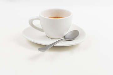 A white coffee glass with a spoon on a white background