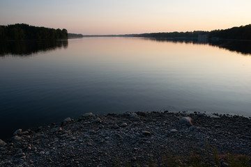 Calm river at sunset in summer