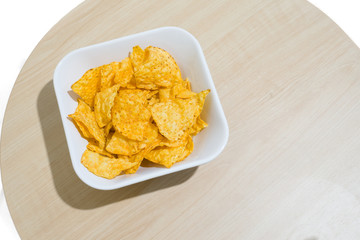 The Corn chip on wooden table and white background