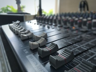 Closeup slider buttons of sound controller instrument.