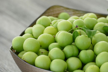 sour green plums, double bunch of plums