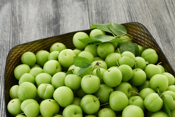 close-up of green sour plums, fresh green plums,