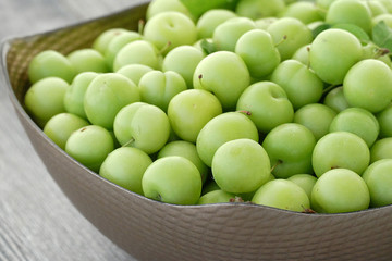 close-up of green sour plums, fresh green plums,