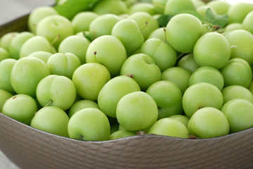 close-up of green sour plums, fresh green plums,