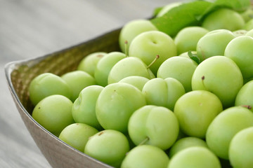 close-up of green sour plums, fresh green plums,