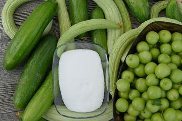 fresh organic cucumbers, green sour plums and salt,