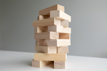 Wood block tower with architecture model, Concept Risk of management and strategy plan, growth business success process and team work