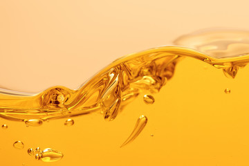 wavy yellow bright liquid with splash and bubbles isolated on yellow
