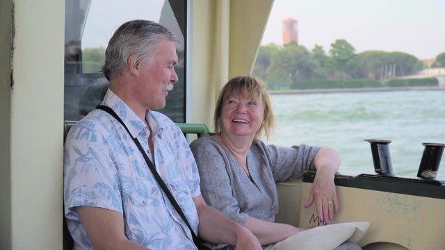 Senior Couple Relaxing On Boat Journey