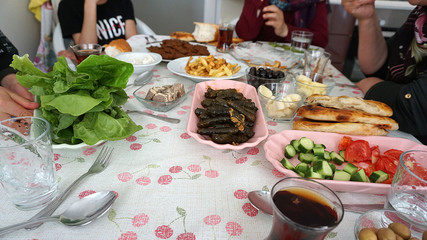 Turkish breakfast table and turkey specific foods, raw meatballs (cig kofte) leaves stuffed patatas fries etc ...