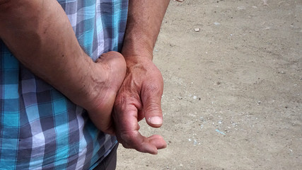 A man standing with his hands behind his back,