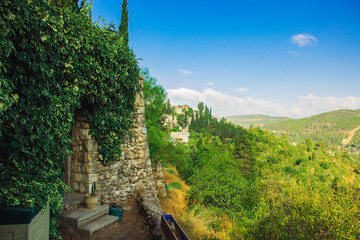 fairy tale stone farm house door entrance under arch of garden plants, romantic scenic country side hill land in some New Zealand village  