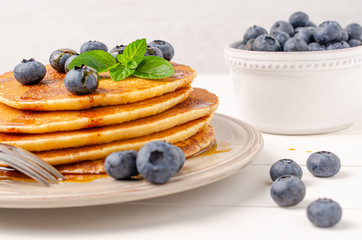 Stack of pancakes with fresh blueberry and caramel syrup. Top view