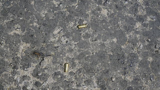 Pistol Bullet Casings Falling To The Ground,