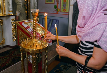 Orthodox parishioners light candles, pray for their needs
