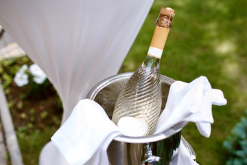 Bottle of champagne in a bucket with ice, top view, party, champagne on the lawn © halcon1