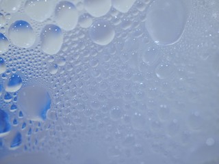 Water droplets surface on clear glass  In blue and white tones