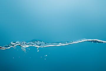 pure water with splash and drops on blue background
