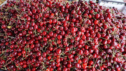 peddler sells cherries on the counter