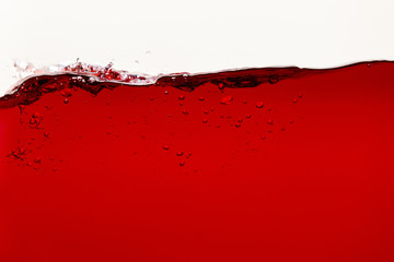 red bright liquid with bubbles isolated on white