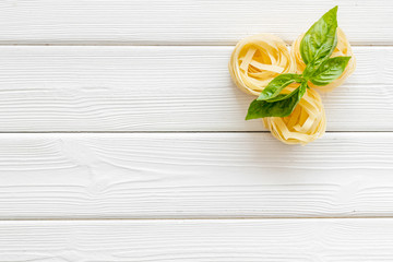 Italian pasta on white wooden table background top view mock up