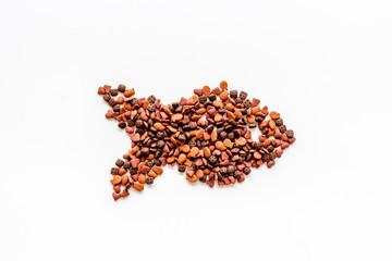 Cat dry food in fish shape on white background top view copyspace