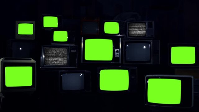 Stacked retro TVs turning on Green Screens. Blue Dark Tone. You can replace green screen with the footage or picture you want with “Keying” effect in AE (check out tutorials on Internet).
