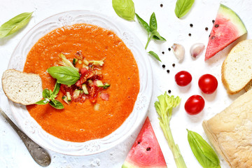 salmorejo- cold soup made of tomatoes and watermelon . Spanish cuisine. soup with bread, butter, celery, cucumber. paleo diet. Orange color. top view