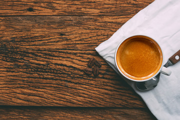 Coffee cup and beans on old wood table. espresso