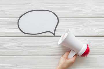 Announcement with megaphone and bubble on white wooden background top view mock up